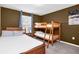 Bedroom with full-over-full bunk bed and window with blinds at 1804 Gobi Dr, Kissimmee, FL 34747