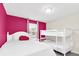 Bedroom with queen bed, pink walls and white bunk bed at 1804 Gobi Dr, Kissimmee, FL 34747