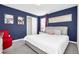 Bedroom with queen bed, navy blue walls, and closet at 1804 Gobi Dr, Kissimmee, FL 34747