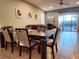 Dining area with dark wood table and six chairs, overlooking the pool at 1804 Gobi Dr, Kissimmee, FL 34747