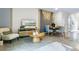 Living room features a comfy chair and coffee table near the TV at 2385 Penguin Blvd, Davenport, FL 33837