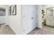 Home hallway with carpet, neutral walls, and a linen closet at 2397 Penguin Blvd, Davenport, FL 33837