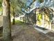 Private backyard with screened patio and mature trees at 2766 White Isle Ln, Orlando, FL 32825