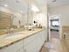 Double vanity bathroom with granite counters and access to bedroom at 2766 White Isle Ln, Orlando, FL 32825
