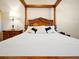 Main bedroom with a wooden canopy bed and ensuite bathroom at 2766 White Isle Ln, Orlando, FL 32825