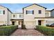 Two-story townhome with brick paver driveway and landscaping at 2766 White Isle Ln, Orlando, FL 32825