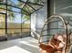 Relaxing screened porch with hanging chair and view of backyard at 2766 White Isle Ln, Orlando, FL 32825
