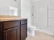 Bathroom with dark brown vanity and shower stall at 418 Caraway Dr, Kissimmee, FL 34759