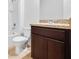 Clean bathroom with dark brown vanity and neutral tile flooring at 418 Caraway Dr, Kissimmee, FL 34759