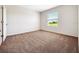 Bright bedroom with carpeted floor and window with blinds at 418 Caraway Dr, Kissimmee, FL 34759