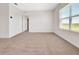 Bright bedroom featuring neutral carpet and window with blinds at 418 Caraway Dr, Kissimmee, FL 34759