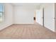 Well-lit bedroom with carpet flooring and access to another room at 418 Caraway Dr, Kissimmee, FL 34759