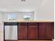 Kitchen features dark brown cabinets and stainless steel dishwasher at 418 Caraway Dr, Kissimmee, FL 34759
