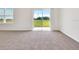 Spacious living area featuring sliding glass doors and neutral carpeting at 418 Caraway Dr, Kissimmee, FL 34759