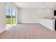 Bright living room with sliding glass doors and neutral carpet at 418 Caraway Dr, Kissimmee, FL 34759