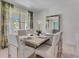 Elegant dining room featuring a large table, neutral decor, and natural light at 437 Caraway Dr, Kissimmee, FL 34759