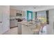 Modern kitchen with granite countertops, stainless steel appliances, and an island at 437 Caraway Dr, Kissimmee, FL 34759