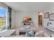 Spacious living room showcasing a large window, comfortable seating, and a modern TV at 443 Caraway Dr, Kissimmee, FL 34759