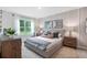 Spacious bedroom with large window, plush bed, and wood nightstands at 528 Nogales Ct, Kissimmee, FL 34758