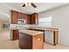 Bright kitchen features a kitchen island and wood cabinets at 6163 Froggatt St, Orlando, FL 32835