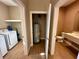 Hallway with access to laundry, bathroom, and water heater at 7451 Brooklyn Dr, Kissimmee, FL 34747