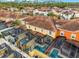 Aerial view of community with multiple townhouses, pools, and tennis courts at 8939 Bismarck Palm Rd, Kissimmee, FL 34747