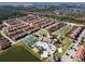 Aerial view of community with pool, tennis courts, and numerous townhouses at 8939 Bismarck Palm Rd, Kissimmee, FL 34747