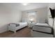 Bedroom with two twin beds, nightstand, and TV at 8939 Bismarck Palm Rd, Kissimmee, FL 34747