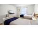 Bedroom with two twin beds, nightstand, and TV at 8939 Bismarck Palm Rd, Kissimmee, FL 34747