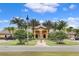 Luxury resort entrance with lush landscaping and palm trees at 8939 Bismarck Palm Rd, Kissimmee, FL 34747