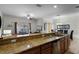 Open concept kitchen with granite island and breakfast bar at 8939 Bismarck Palm Rd, Kissimmee, FL 34747