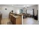 Open kitchen with breakfast bar and view to living room at 8939 Bismarck Palm Rd, Kissimmee, FL 34747