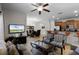 Bright living room with comfy seating, large TV, and adjacent dining area at 8939 Bismarck Palm Rd, Kissimmee, FL 34747