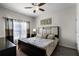 Spacious Primary bedroom with king-size bed and ceiling fan at 8939 Bismarck Palm Rd, Kissimmee, FL 34747