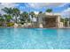 Relaxing rock grotto waterfall feature in the pool area at 8939 Bismarck Palm Rd, Kissimmee, FL 34747