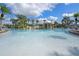 Large community pool with waterfall feature and palm trees at 8939 Bismarck Palm Rd, Kissimmee, FL 34747