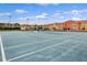 Outdoor tennis court with residential buildings in background at 8939 Bismarck Palm Rd, Kissimmee, FL 34747