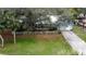House with a large yard, driveway, and white picket fence at 1215 Timberidge Dr, Lakeland, FL 33809