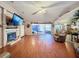 Spacious living area with hardwood floors, fireplace and access to patio at 1215 Timberidge Dr, Lakeland, FL 33809