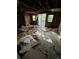 Damaged living room with exposed ceiling and flooring at 15924 Old Cheney Hwy, Orlando, FL 32833
