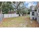 Backyard view showing a large grassy area and wooden fence at 1613 Christy Ave, Orlando, FL 32803