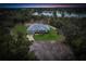 Single-story home with pool and lake view at sunset at 2008 Prescott Blvd, Deltona, FL 32738