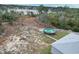 Aerial view of backyard with above ground pool, fire pit, and lake view at 2008 Prescott Blvd, Deltona, FL 32738