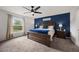 Spacious main bedroom with king bed, blue accent wall, and natural light at 2008 Prescott Blvd, Deltona, FL 32738