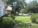 Landscaped front yard with mature trees and lush green grass at 2309 Dunbury Ct, Winter Park, FL 32792