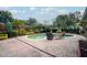 Kidney-shaped pool with brick patio, wooden benches, and outdoor seating at 271 Fallen Palm Dr, Casselberry, FL 32707