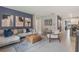 Open living room showcasing stylish furniture and a view into the kitchen at 441 Cinnamon Dr, Kissimmee, FL 34759
