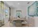 Elegant dining room featuring a large table, modern chairs, and stylish decor at 447 Caraway Dr, Kissimmee, FL 34759