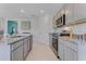 Modern kitchen with granite countertops, stainless steel appliances, and an island at 447 Caraway Dr, Kissimmee, FL 34759