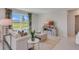 Bright living room with comfy seating, large windows, and modern TV stand at 447 Caraway Dr, Kissimmee, FL 34759